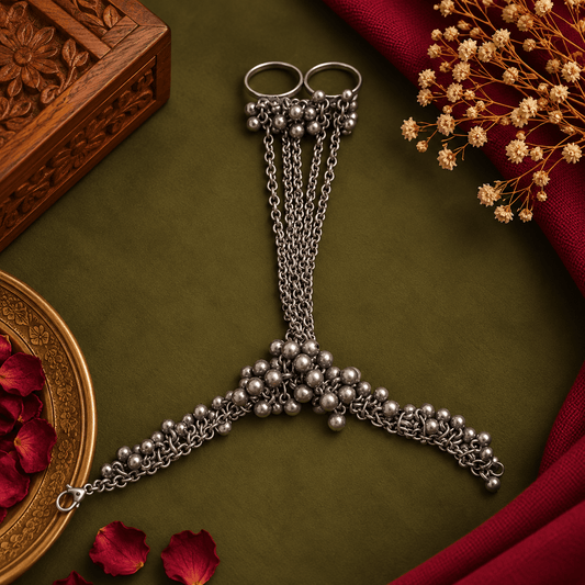 Woman wearing a ghungroo charm oxidized silver hathphool with two rings from The Mirage Fashion.