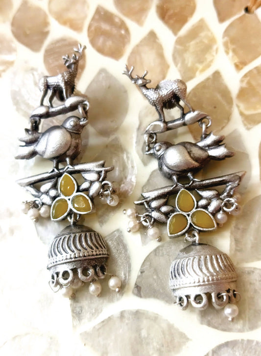 Mirage  -Antique Silver Animal Motif Jhumka Earrings with Magenta Stone Accents