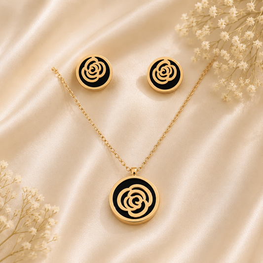 Anti tarnish rose gold floral pendant necklace with black enamel detailing and matching stud earrings for women, elegant designer jewellery set.