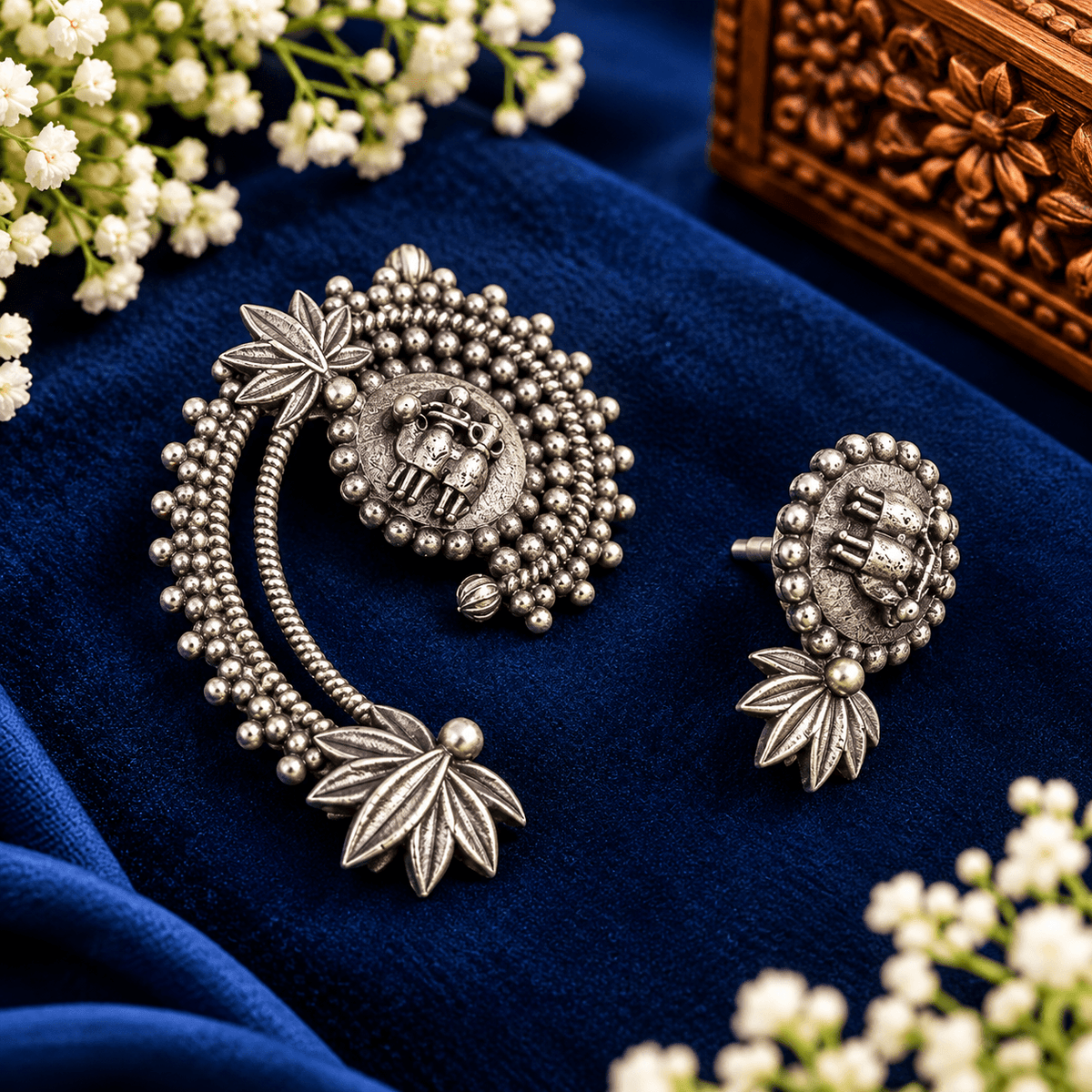 Antique silver-tone elephant motif earrings with beaded detailing and sculpted leaf accents