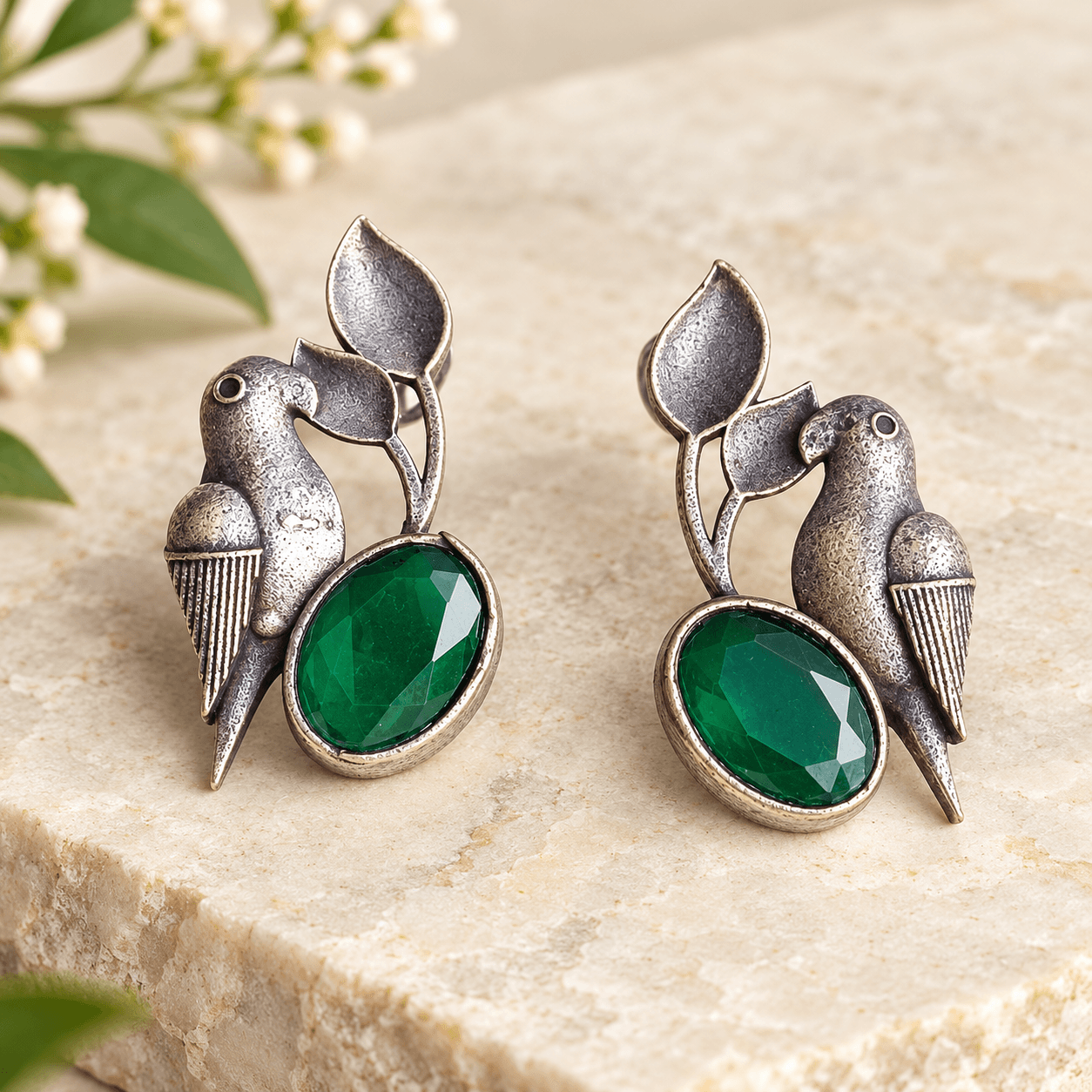 Bird and leaf statement earrings with oval emerald-green stones and textured antique silver-tone detailing