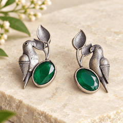 Bird and leaf statement earrings with oval emerald-green stones and textured antique silver-tone detailing