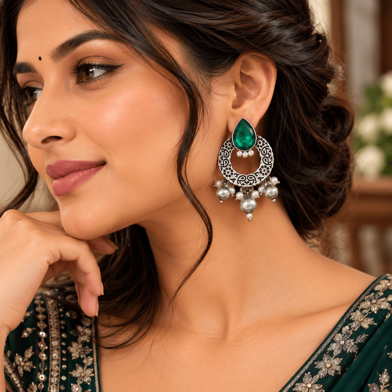 Emerald-green teardrop stone oxidized earrings with circular filigree frames and pearl-style dangling beads