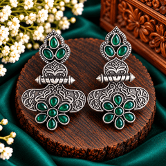 Emerald green floral statement earrings with intricate oxidized silver-tone ornamental detailing