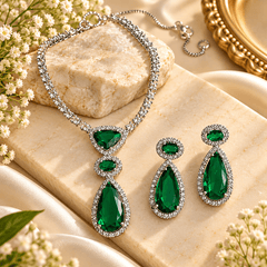 Emerald green teardrop gemstone necklace with silver-tone crystal detailing and matching drop earrings