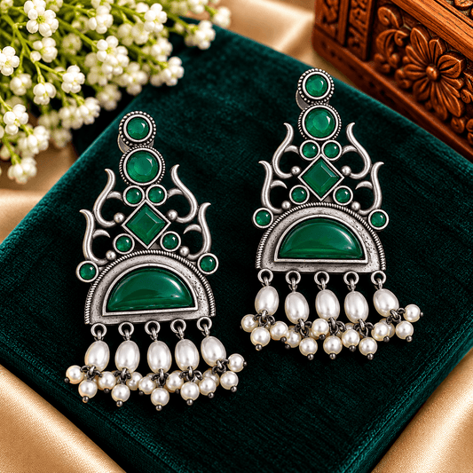 Emerald-green stone-work oxidized chandelier earrings with geometric silver-tone detailing and cascading pearl-style beads
