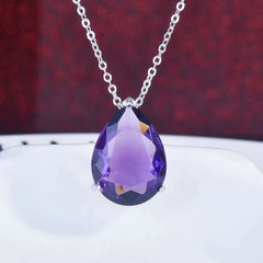 A teardrop-shaped purple crystal pendant necklace and matching earrings set in a silver-tone frame | THE MIRAGE  FASFHION 