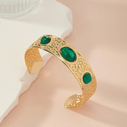 Gold tone green stone kada bangle for women with engraved detailing