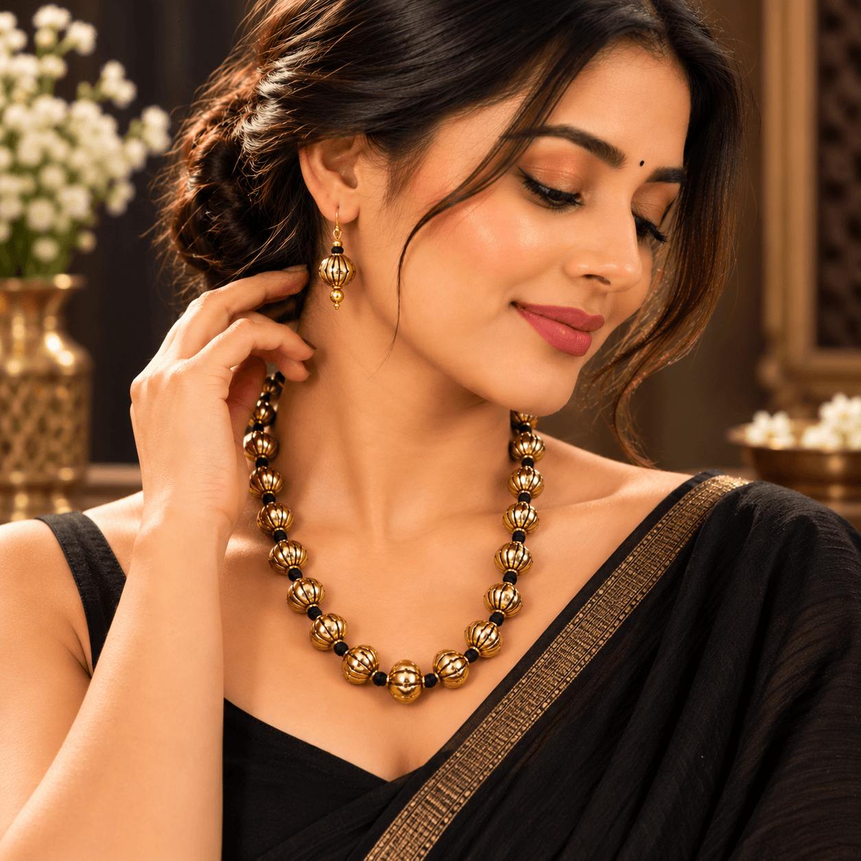 Gold-tone beaded necklace with black thread and matching drop earrings