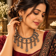 Oxidized silver tribal necklace set with floral motifs and hanging charms