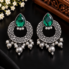 Emerald-green teardrop stone oxidized earrings with circular filigree frames and pearl-style dangling beads