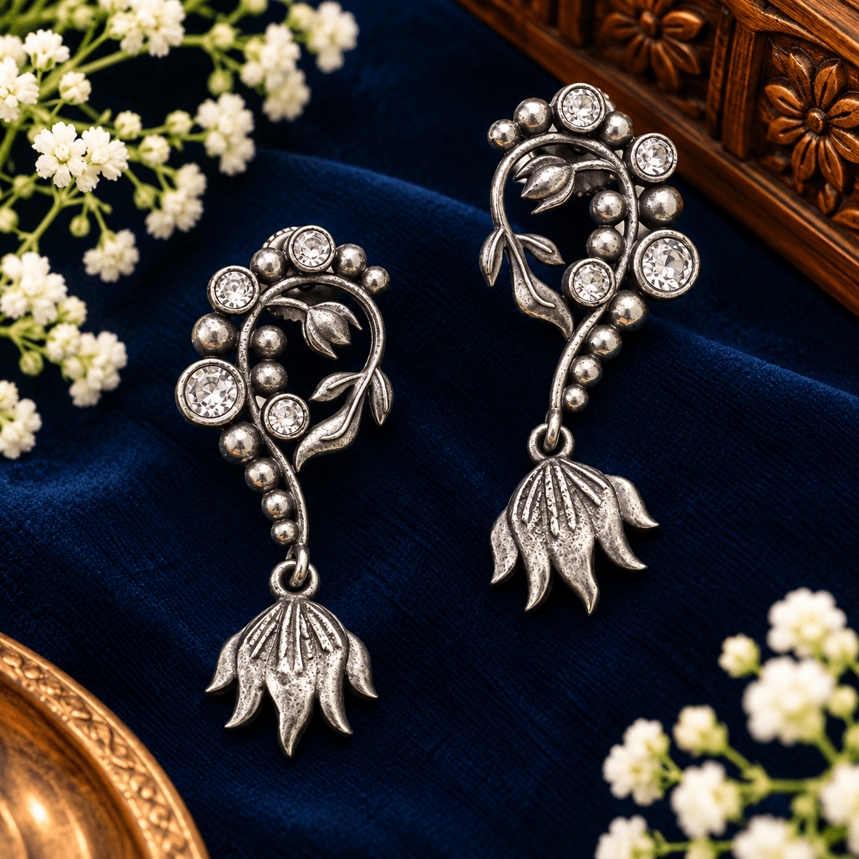 Oxidized silver-tone floral drop earrings with vine and leaf detailing, clear stones and sculpted flower pendants