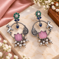 Pink lotus stone-work oxidized earrings with green and blue stones, peacock-inspired silver detailing and dangling beads