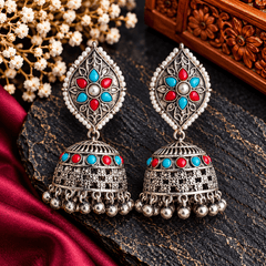 Turquoise blue and red oxidized jhumka earrings with floral filigree, pearl-style borders and metallic bead danglers