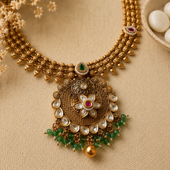 Royal Kundan necklace set with green beads, pearl accents, and matching earrings in antique gold finish.