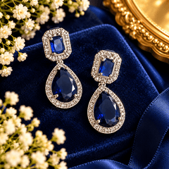 Royal blue teardrop crystal necklace with silver-tone detailing, sparkling clear stone borders and matching drop earrings
