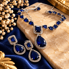 Royal blue teardrop crystal necklace with silver-tone detailing, sparkling clear stone borders and matching drop earrings