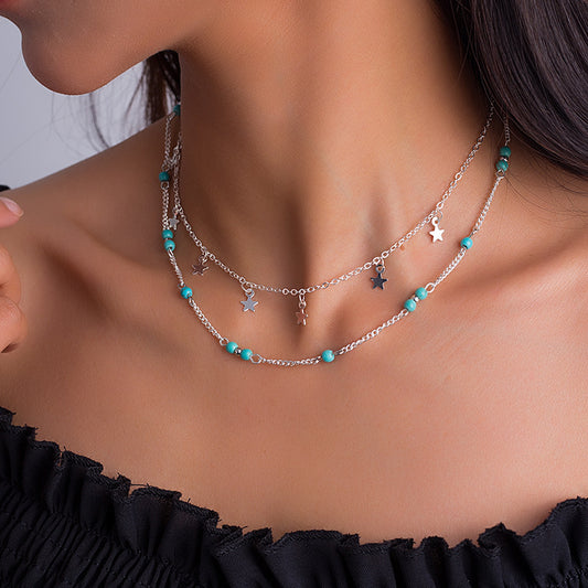 Silver two layer chain necklace with star charms and turquoise beads for women.
