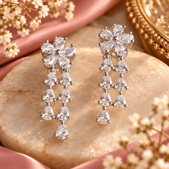 Silver-tone V-shaped crystal necklace with cascading teardrop details and matching long floral drop earrings