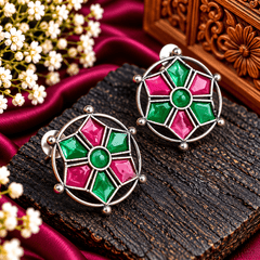 Round oxidized stud earrings with geometric emerald-green and magenta-pink stained-glass-inspired detailing