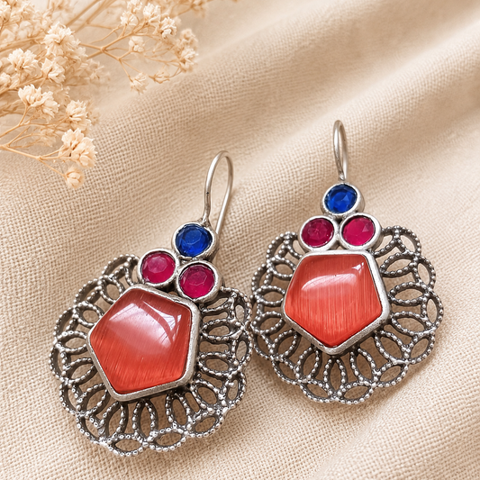 Ornate earrings with red and blue stones 