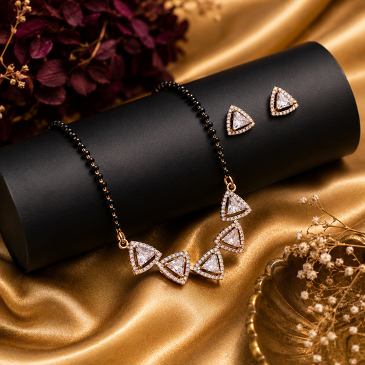 Black beaded mangalsutra with sparkling triangle pendant and matching earrings