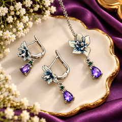 Blue and white floral pendant necklace set with purple teardrop stones, green accents and matching silver-tone earrings