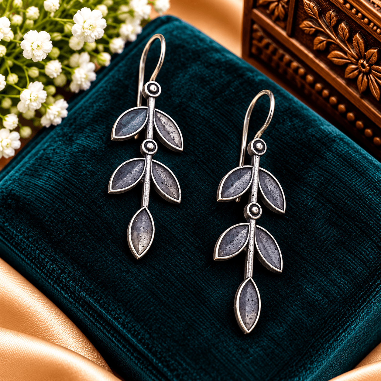 Oxidized silver-tone drop earrings featuring an elongated botanical vine and leaf design