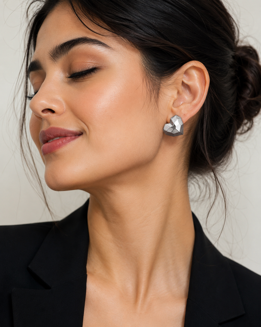 Geometric silver-tone heart stud earrings for women with faceted modern design