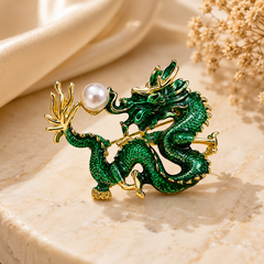 Green dragon brooch with pearl-like accent and gold-tone detailing