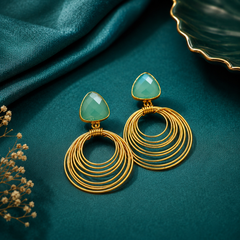 Gold tone geometric drop earrings with green coloured stone and concentric circles
