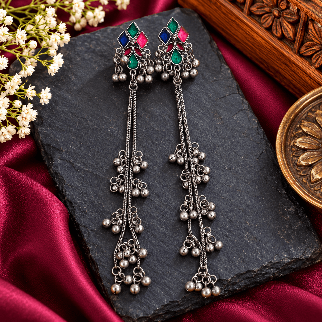 Long Kashmiri-inspired Kangri earrings with multicolour meenakari-style geometric designs, silver-tone chains and dangling bead tassels