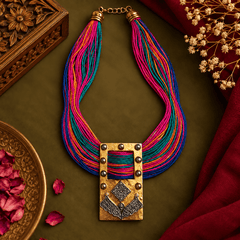 Multicolor pink blue turquoise and orange thread necklace with antique gold-tone tribal pendant