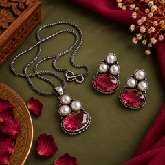 Red oxidized pendant necklace set with red stone and pearl earrings