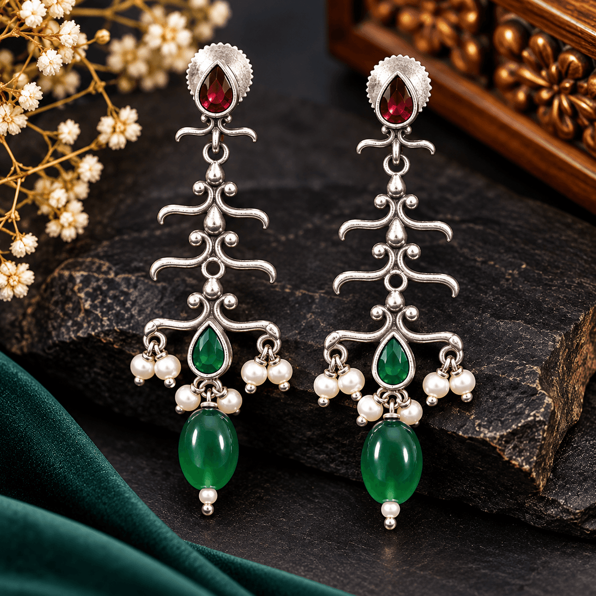 Long oxidized silver-tone dangle earrings with ruby-red and emerald-green accents and pearl-style bead clusters