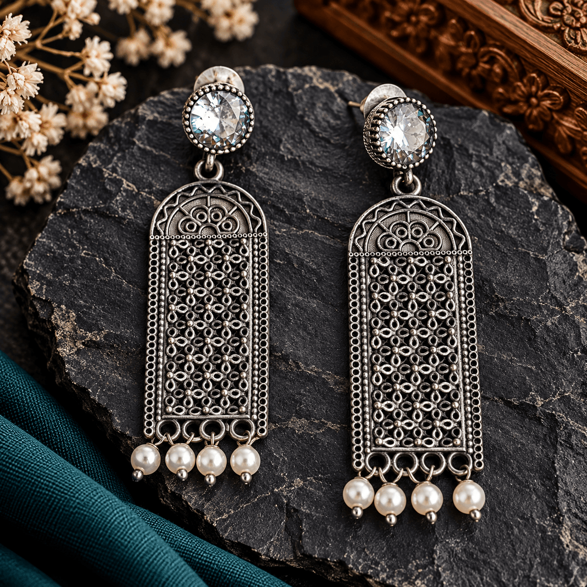 Long oxidized silver-tone filigree earrings with clear round stones and white pearl drops