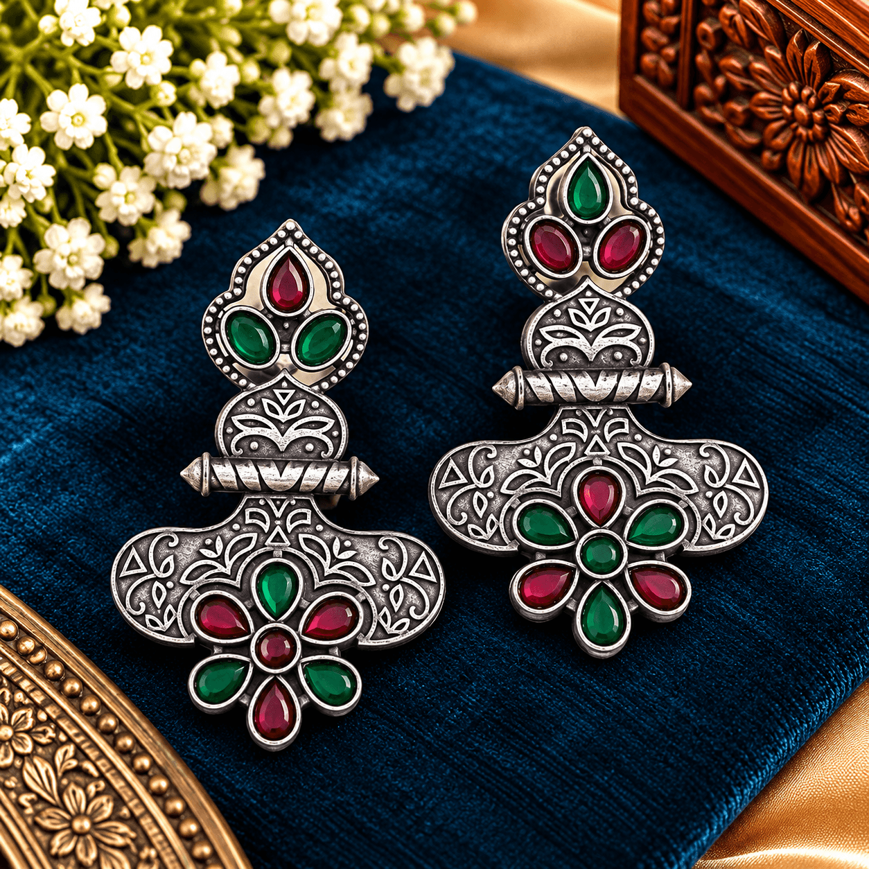 Red and green stone-work oxidized silver-tone statement earrings with intricate floral and geometric detailing