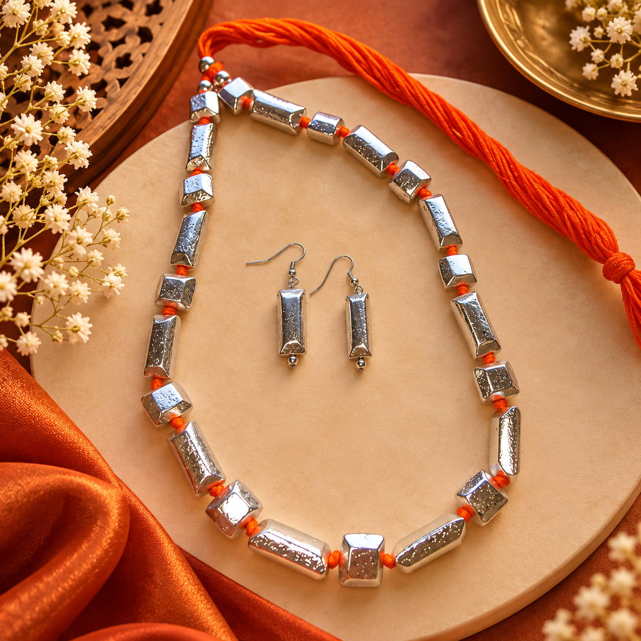 Silver tone orange thread necklace with matching earrings for women